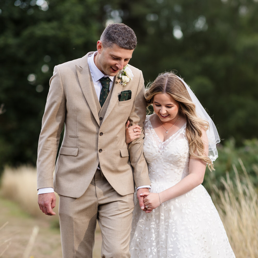 Couple walking together on their wedding day in the Worcestershire countryside