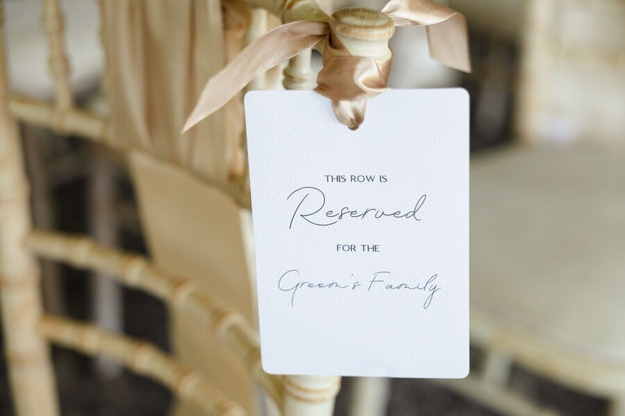 Reserved seat card detail on a chiavari chair at a De Vere Cotswold Water Park wedding ceremony