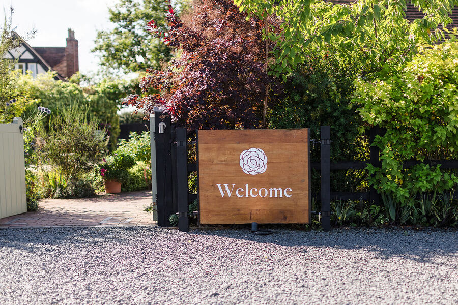 Curradine Barns welcome sign at the entrance gate, Shrawley, Worcestershire